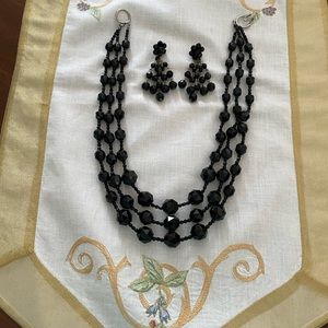 Vintage three strand black beaded necklace with matching earrings.